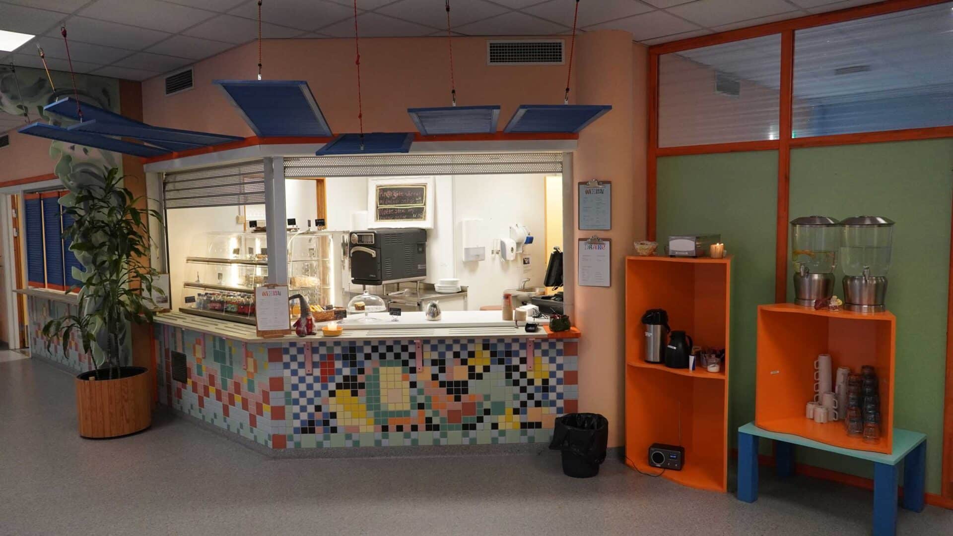 The colourful interior and low counter of Kafe Mat & prat.